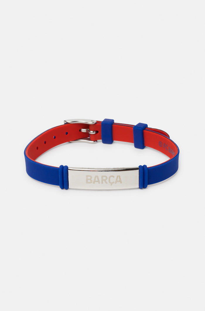 Blue and red silicone bracelet with a silver metal plate engraved with the word "BARÇA"