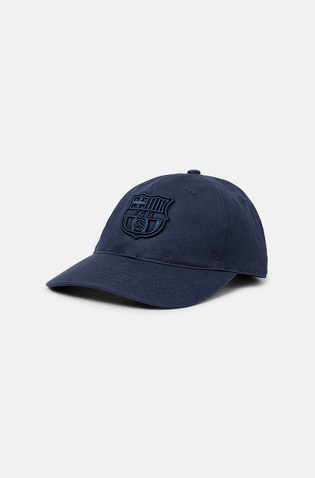 Dark blue FC Barcelona baseball cap with a tonal embroidered Barça crest on the front, featuring a curved brim and classic six-panel design.