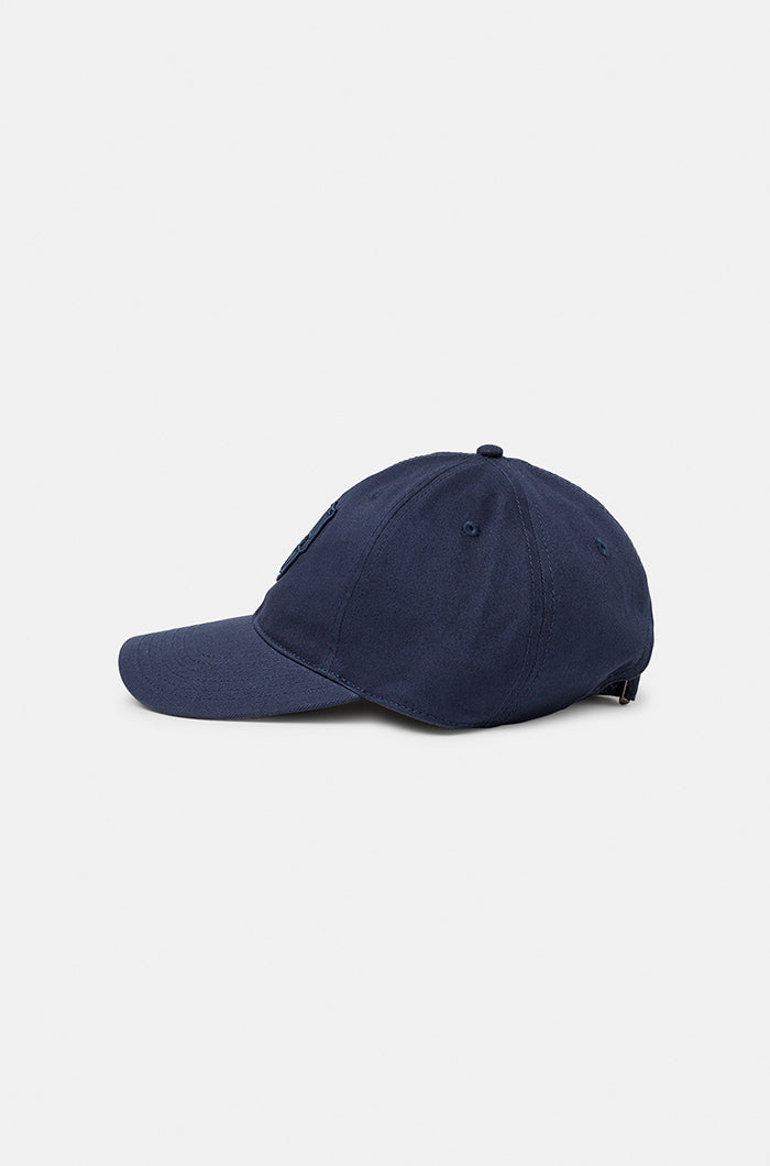 Dark blue FC Barcelona baseball cap with a tonal embroidered Barça crest on the front, featuring a curved brim and classic six-panel design.