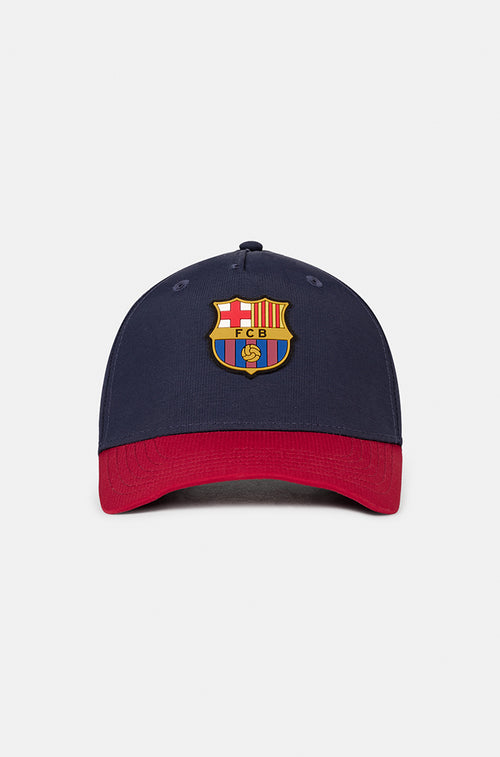 FC Barcelona baseball cap featuring a navy blue crown and a contrasting red visor, embroidered with the official club crest on the front.