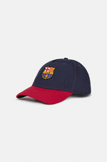 Two-tone FC Barcelona baseball cap featuring a navy blue crown and a red brim, with the club’s full-color crest embroidered on the front.