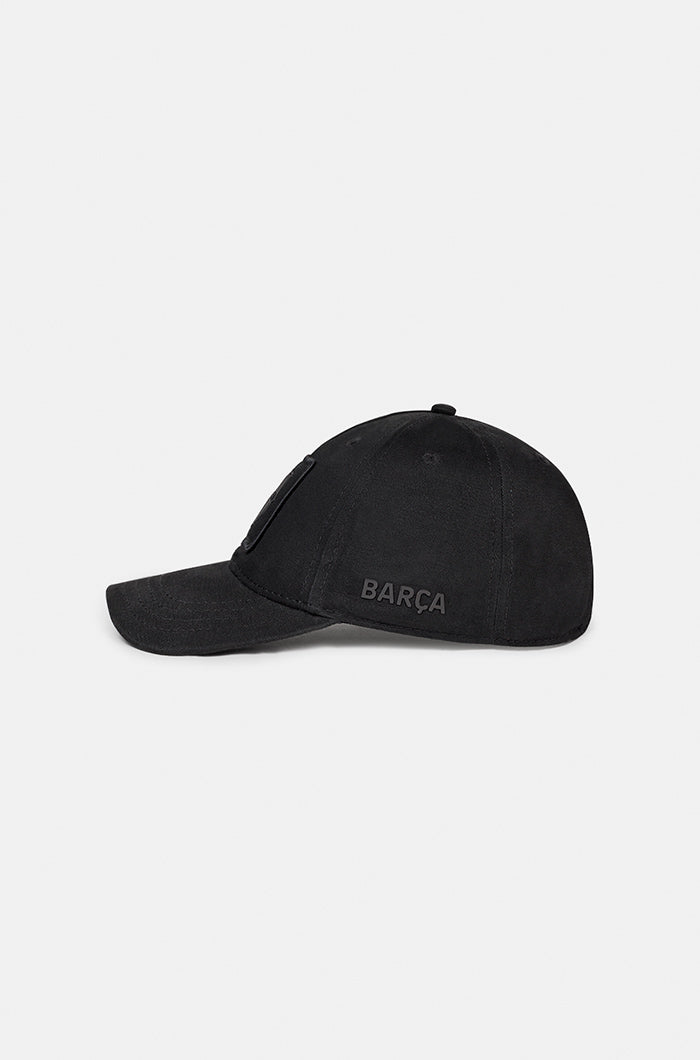 Black FC Barcelona baseball cap with a monochrome embroidered crest on the front panel and the word "BARÇA" stitched on the side