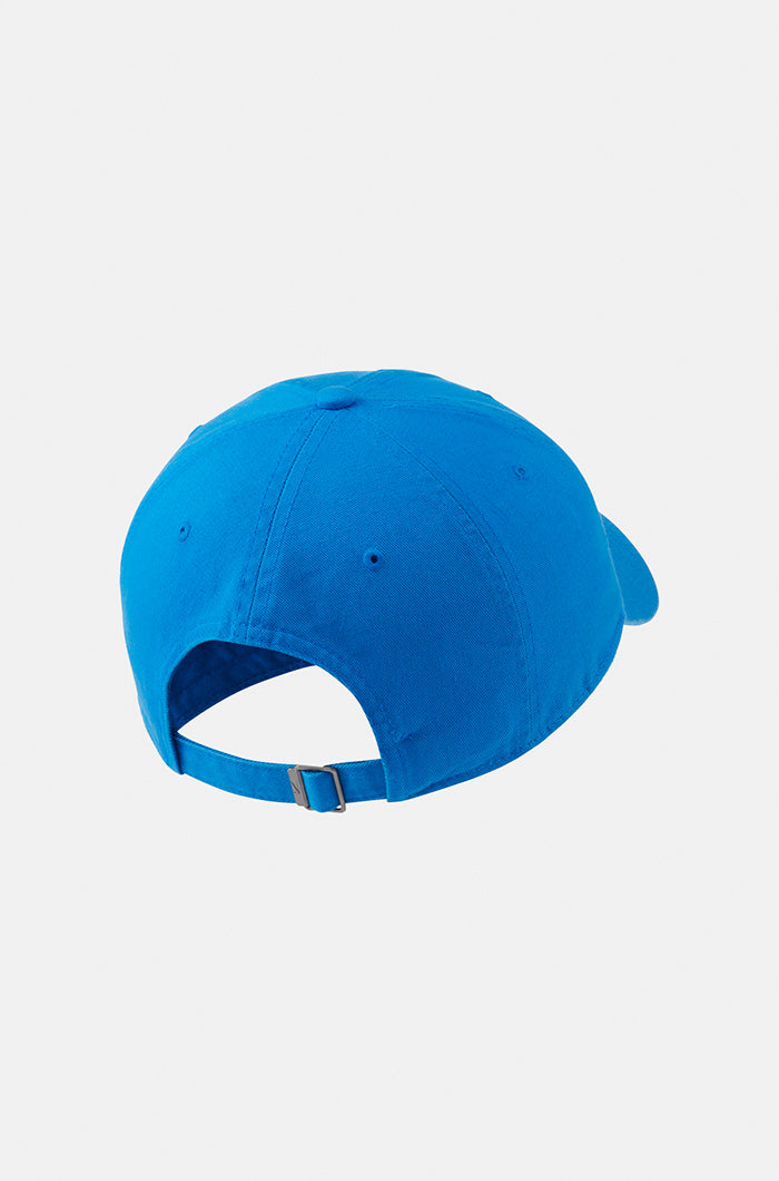 Bright blue FC Barcelona baseball cap featuring the club’s full-color crest on the front and a red Nike swoosh embroidered on the side.