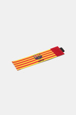 Yellow and red striped FC Barcelona captain's armband featuring the club crest and the word "CAPITÀ" printed in black.