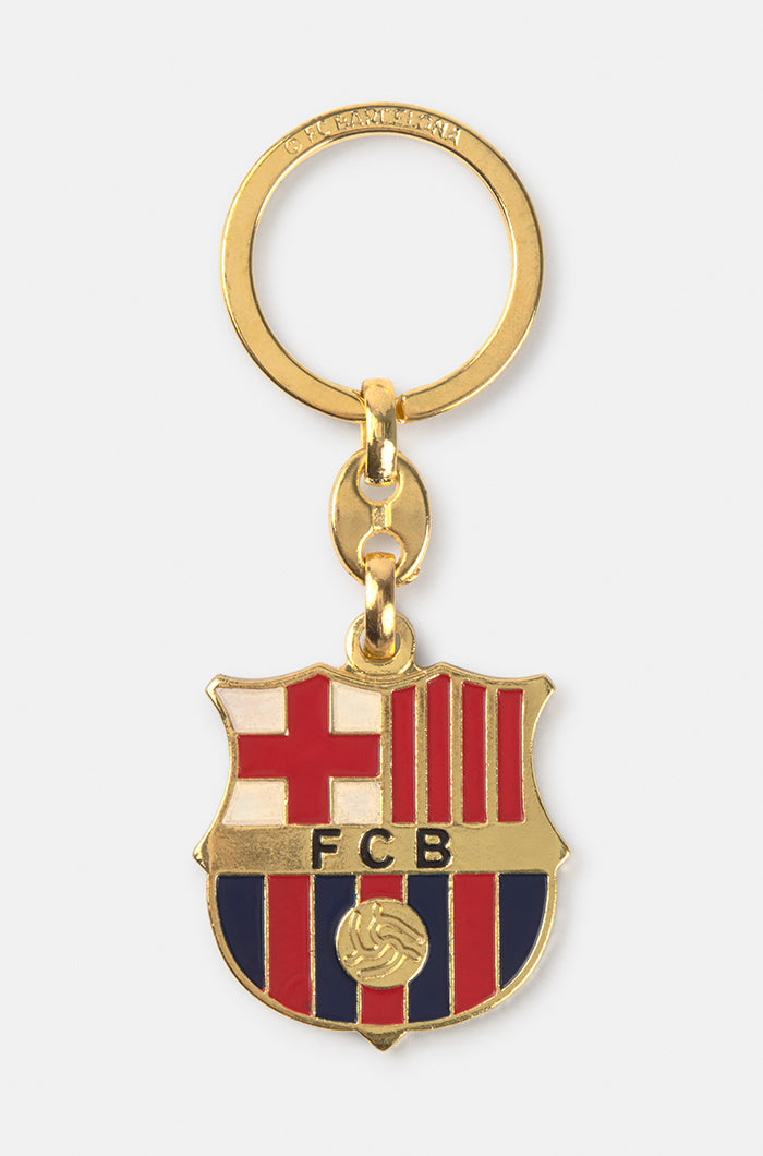 Gold-colored metal keychain with the official FC Barcelona crest in red, blue, and white.